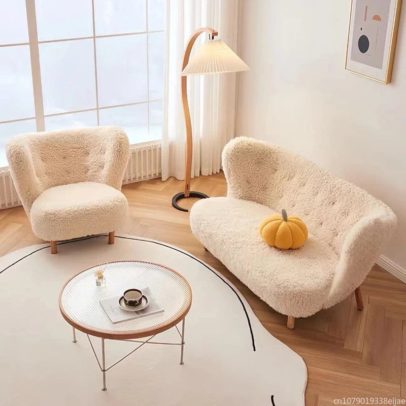 Cozy living room with fluffy armchair, sofa, and coffee table near a window.
