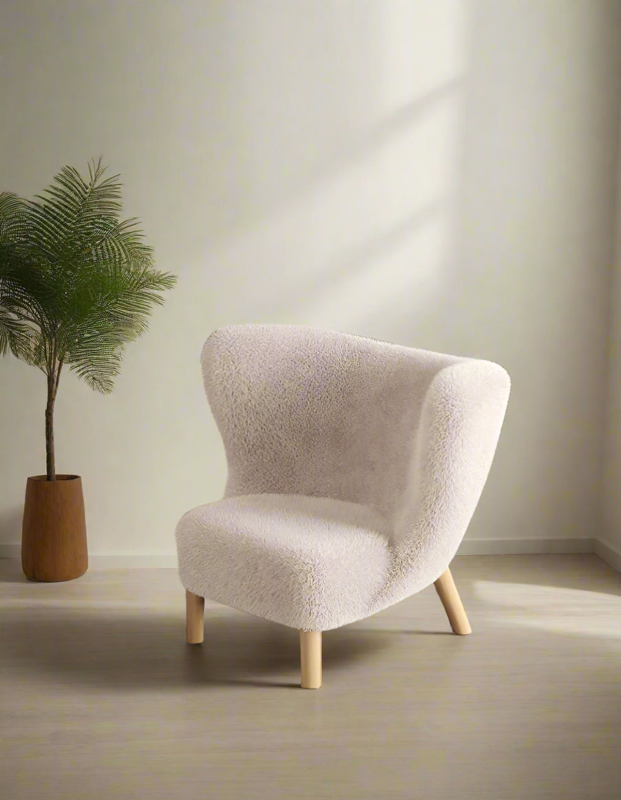 Beige armchair in a modern living room setting with a television and shelves.